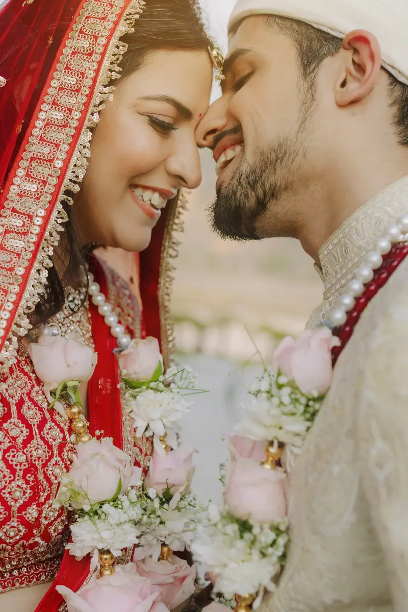 A bride and groom nose to nose after the ceremony