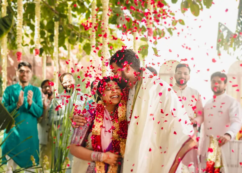 Rose petals falling as the couple walk in